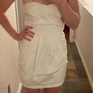 White sleeveless mini dress with pockets.